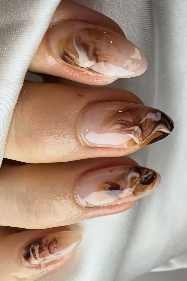 Elegant brown marble nails with glossy finish designed for a chic and sophisticated look.