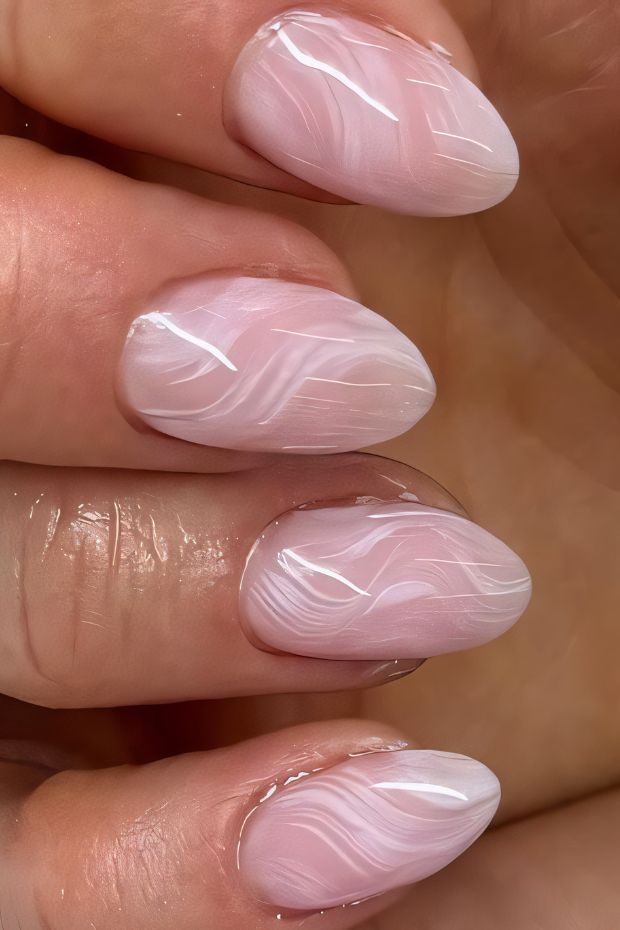 Elegant pink nail design with soft swirls, perfect for a chic and sophisticated look.