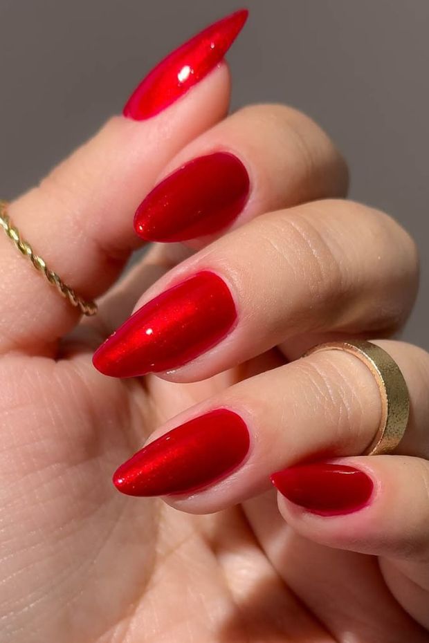 Stiletto red nails with a glossy finish, showcasing a bold and glamorous nail design perfect for any occasion.