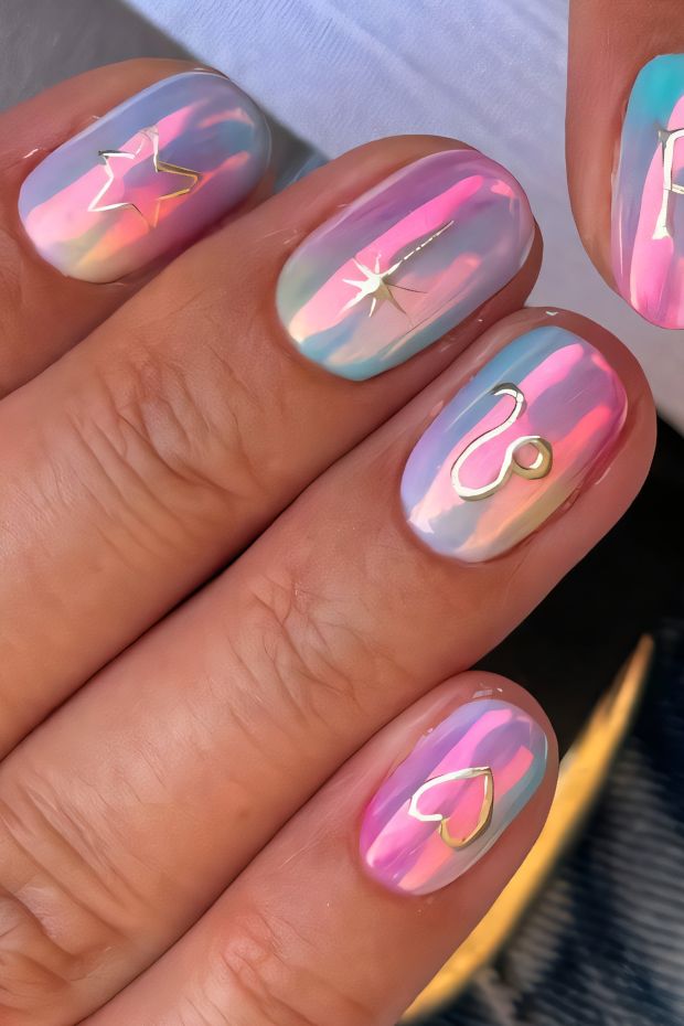 Pastel rainbow birthday nails with gold accents featuring hearts and stars for a festive celebration.