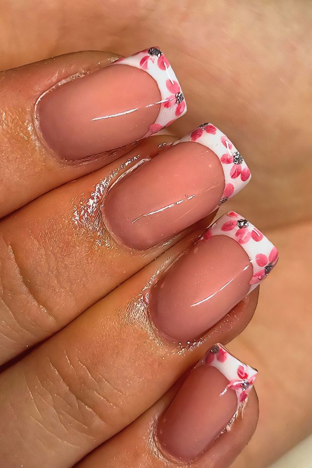 Birthday nails featuring pink floral French tips, designed for a festive and elegant celebration.