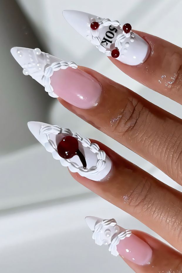 Elegant white birthday nails with red accents and intricate designs, perfect for a festive celebration and special occasions.