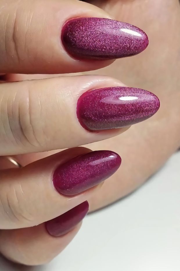 Glamorous red nails with a shimmering finish and a gradient effect, perfect for stylish nail art enthusiasts.
