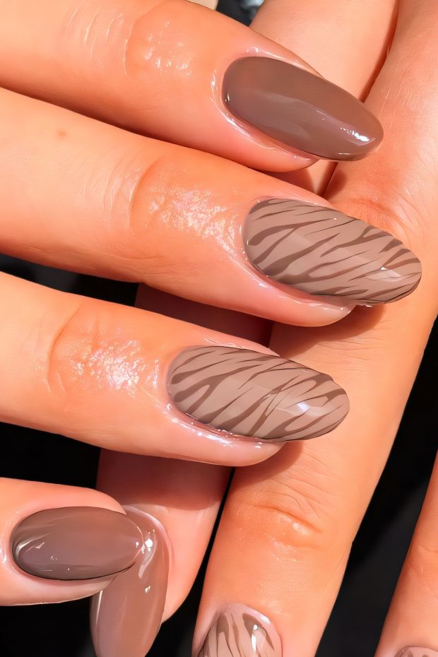 Stylish brown nails with zebra stripes, showcasing a vibrant and modern nail art design for a daring look.