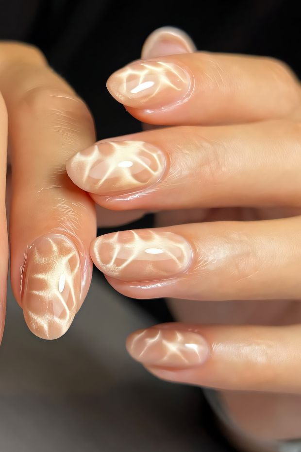 Sheer nude nails with delicate, light patterns, perfect for a sophisticated and subtle nail design.