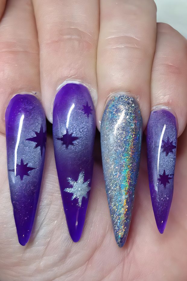 Cosmic purple stiletto nails with silver star accents and glittery details for a stellar manicure.