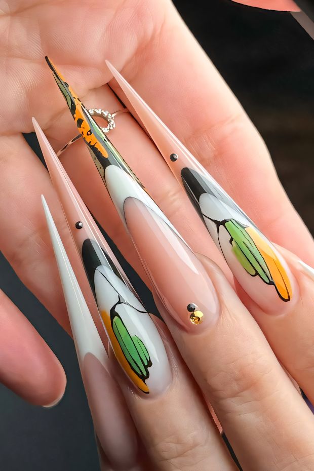 Artistic stiletto nails featuring floral designs in vibrant colors against a nude base for a bold look.