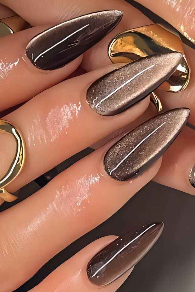 Elegant brown ombre nails with glossy finish showcasing sharp elongated shapes and rich tones.