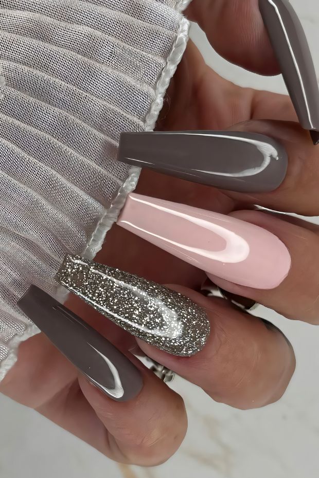 Simple nail design with neutrals and glitter accent, elegant long nails in shades of gray, pink, and silver.