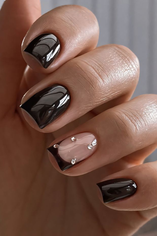 Elegant brown and nude nail art with gems, featuring a mix of glossy and matte finishes for a chic look.