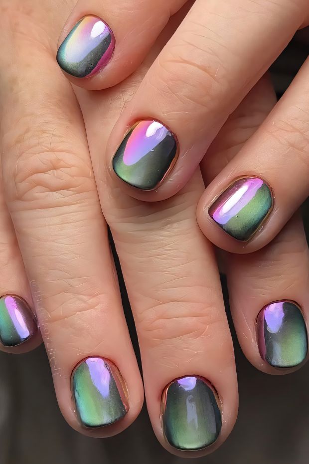 Iridescent short nails with a gradient design in green, purple, and pink tones, shining elegantly.
