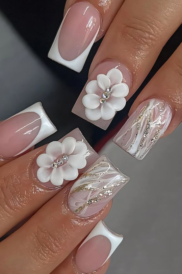 Elegant birthday nail art with floral designs, sparkling accents, and nude tones on long square nails.