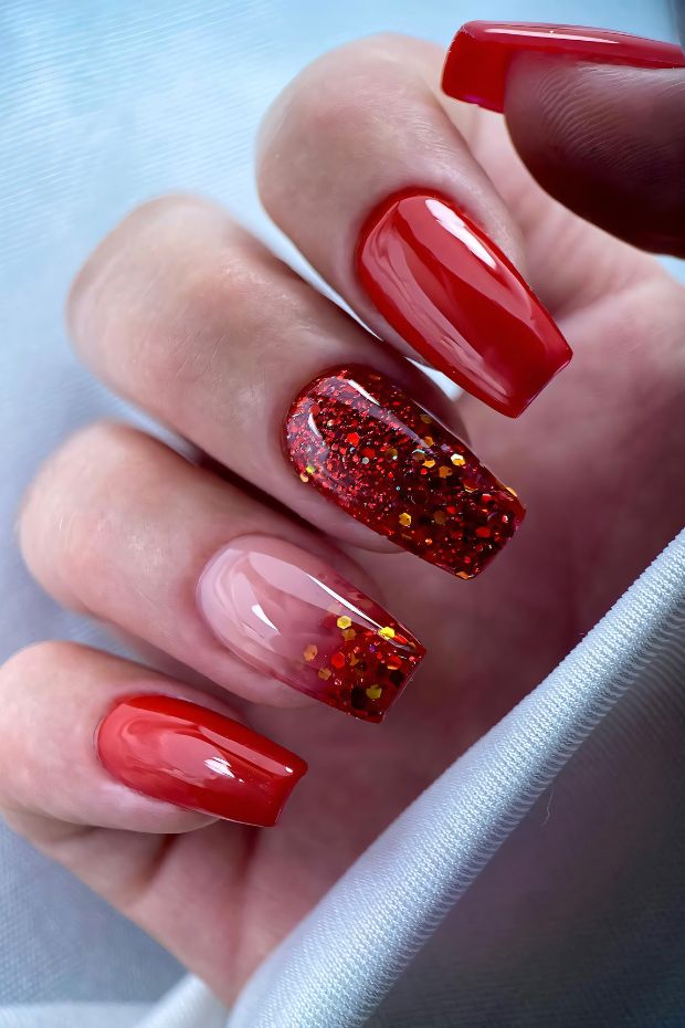Vibrant red nail art featuring glossy finish and a sparkling glitter accent nail with golden glitter details.