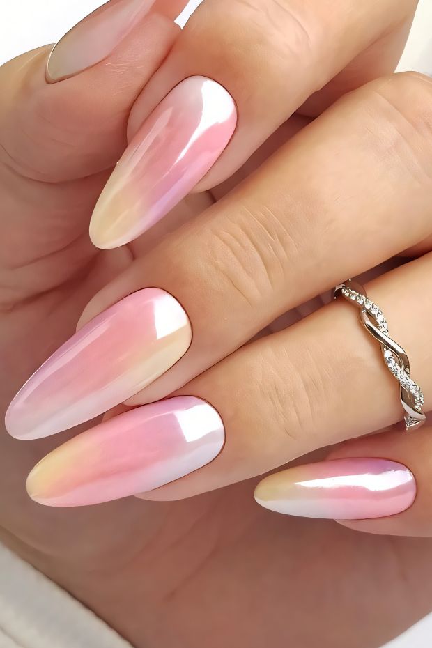 Elegant gradient nail design with pink and white shades, featuring long almond-shaped nails and a glossy finish.