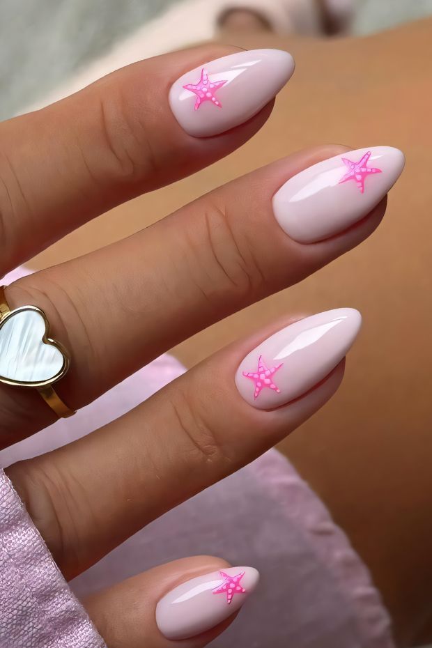 Nude nails with pink starfish design for a trendy summer look.