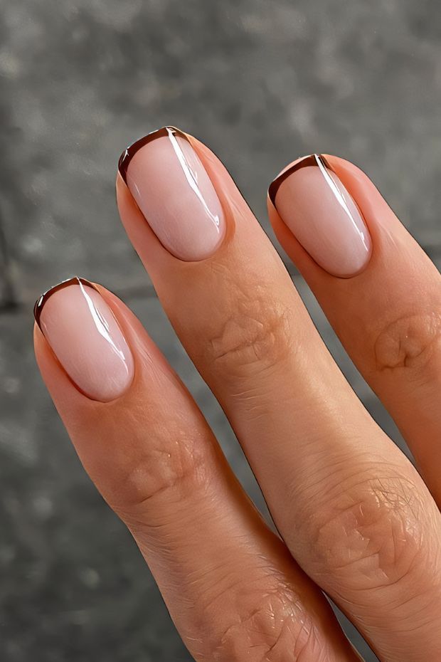 Elegant short nude nails with brown tips, perfect for a chic minimalist look.