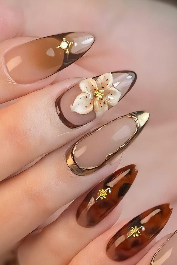 Elegant birthday nail design with floral accents and glossy finishes in warm nude tones.