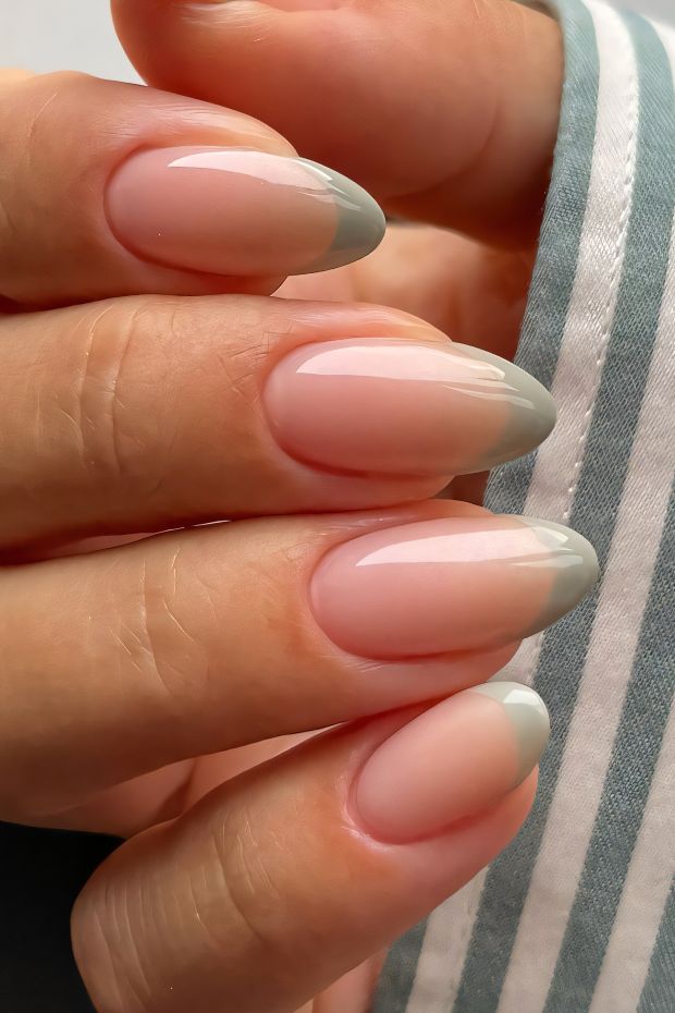 Elegant ombre nail design featuring nude base and chic gray tips for a sophisticated look.