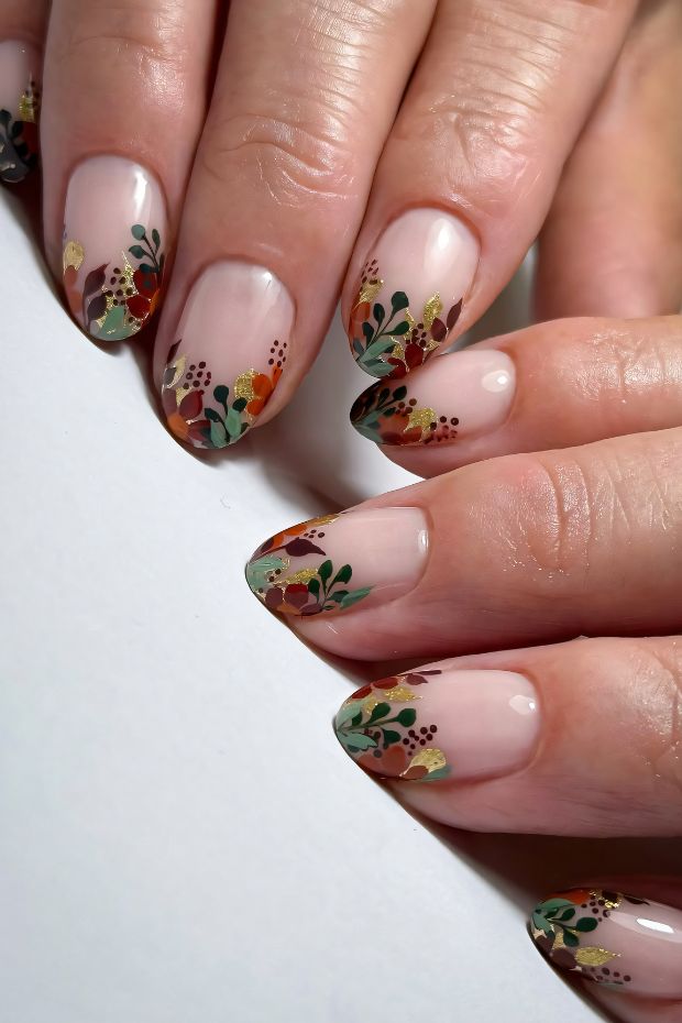 Short nails design featuring floral accents in earthy tones with intricate details and a nude base.