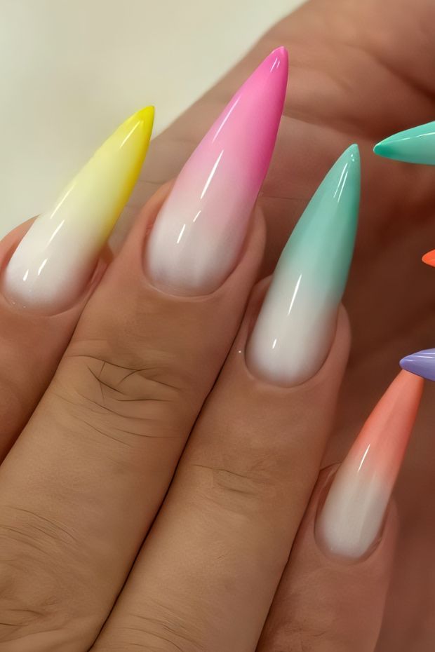 Vibrant stiletto nails with colorful ombre effect showcasing yellow, pink, teal, and lavender tips on a natural base.