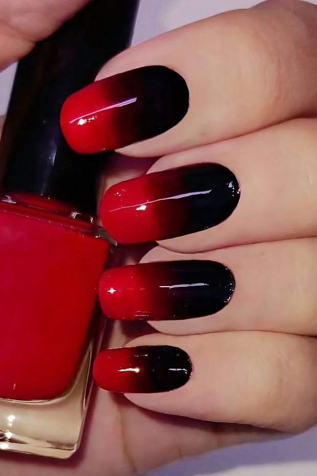 Ombre red to black nail art with a glossy finish perfect for bold styles.