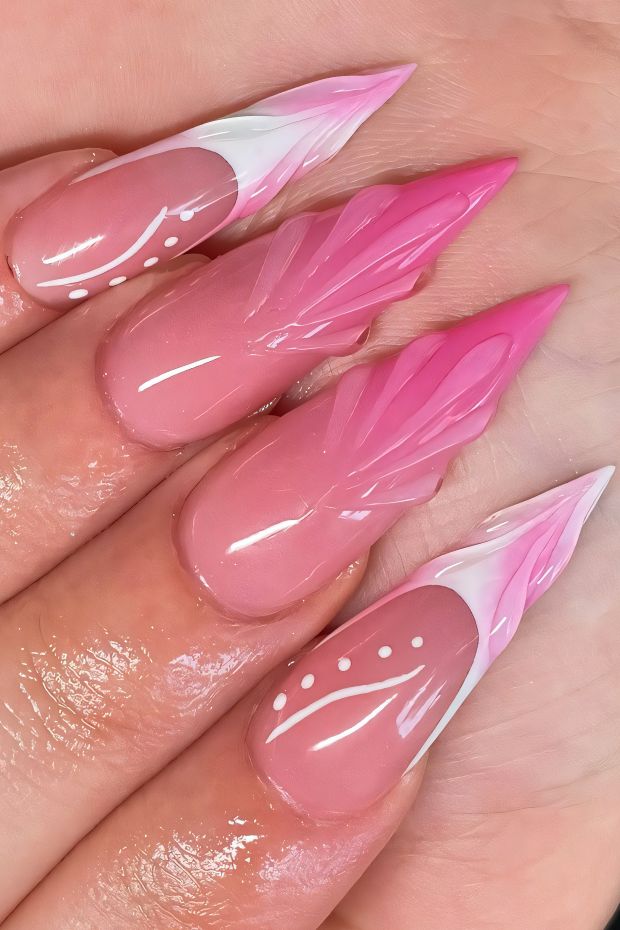 Elegant stiletto nails with pink feather designs and white accents, showcasing a trendy nail art style.