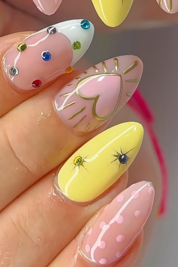 Colorful birthday nails featuring heart designs, dots, and sparkling gems for a festive celebration.