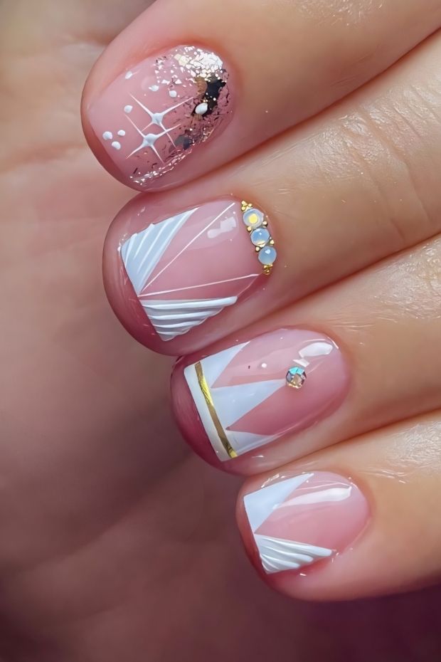 32 Creative Acrylic Nail Ideas You’ll Want to Try This Season 9 Elegant acrylic nails featuring white geometric designs, glittery accents, and decorative gems for a chic look.