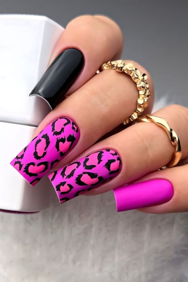 Matte pink and black leopard print nail design with bold patterns for a chic manicure.