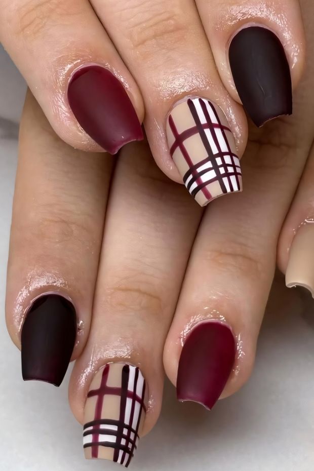 Stylish matte nails in burgundy and nude with a chic plaid design creating a modern fashionable look.