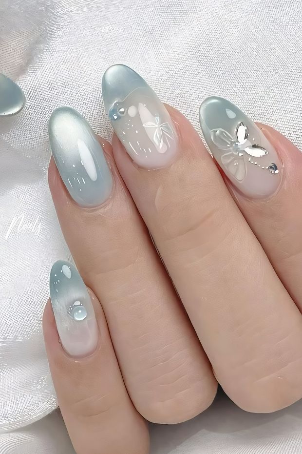 32 Creative Acrylic Nail Ideas You’ll Want to Try This Season 23 Frosted blue acrylic nails with butterfly accents and elegant design for stylish nail art inspiration.