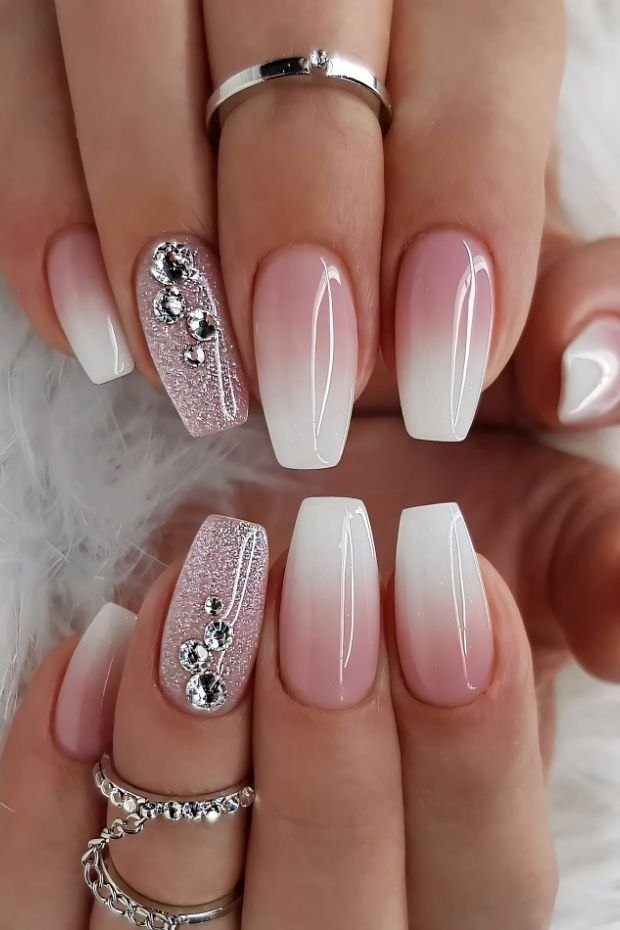 32 Creative Acrylic Nail Ideas You’ll Want to Try This Season 4 Ombre acrylic nails with pink and white tips, glitter accent nail, and rhinestones embellishment for a stylish look.