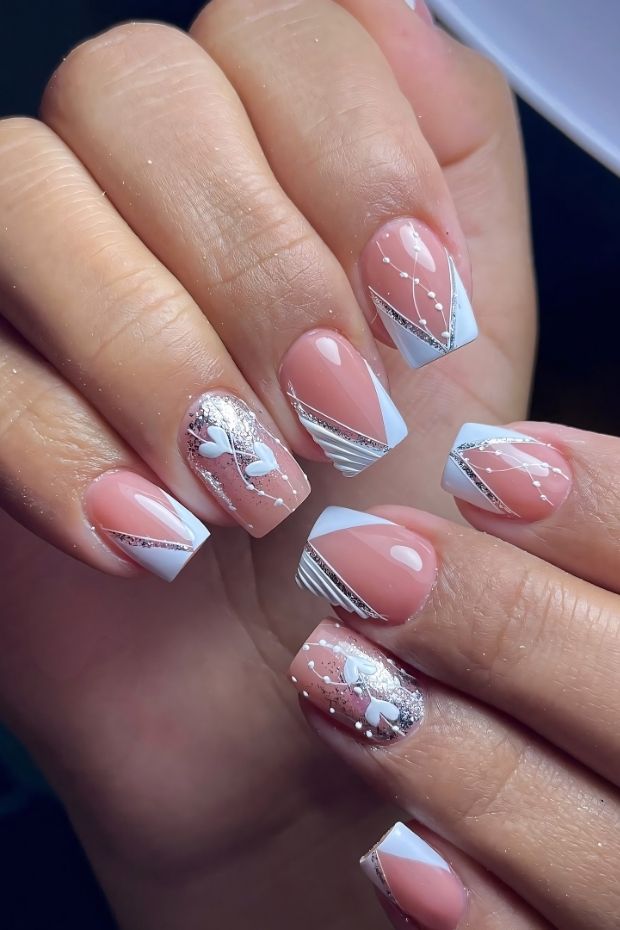 32 Creative Acrylic Nail Ideas You’ll Want to Try This Season 10 Elegant acrylic nails featuring nude and white colors with butterfly designs and geometric patterns for a chic look.