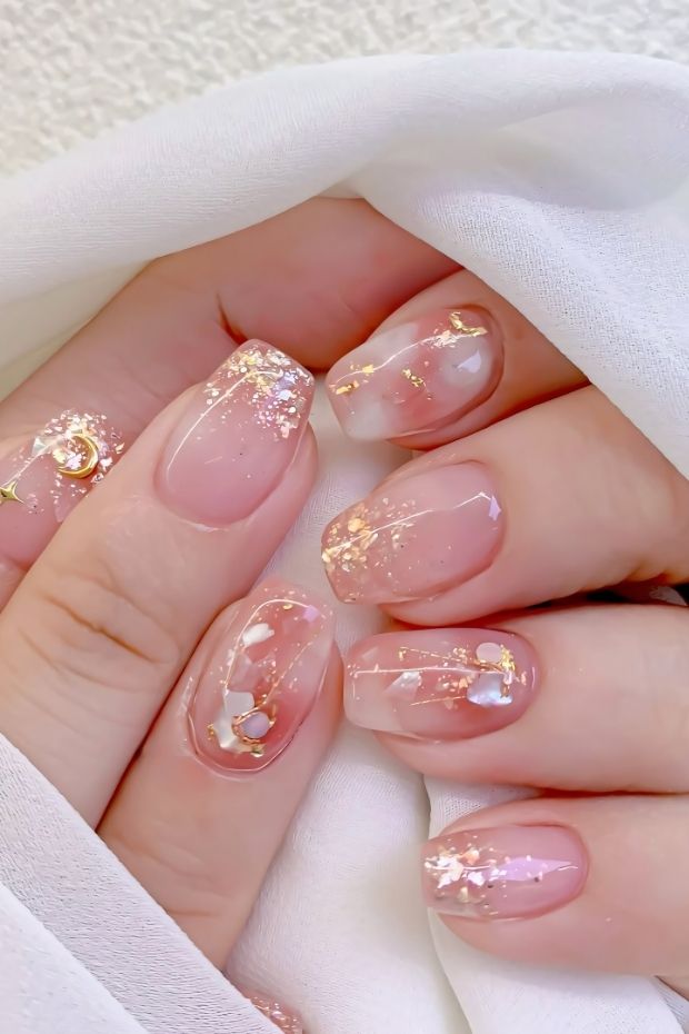 32 Creative Acrylic Nail Ideas You’ll Want to Try This Season 2 Elegant acrylic nails in nude and pink with gold flakes and accents for a stylish look.