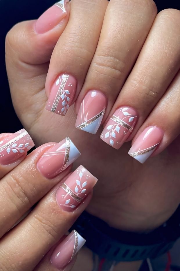 32 Creative Acrylic Nail Ideas You’ll Want to Try This Season 13 Chic acrylic nails featuring floral designs and geometric accents in soft pink and white shades.