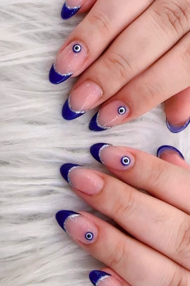 32 Creative Acrylic Nail Ideas You’ll Want to Try This Season 28 Blue acrylic nails with french tips and evil eye designs for a stunning nail art inspiration.