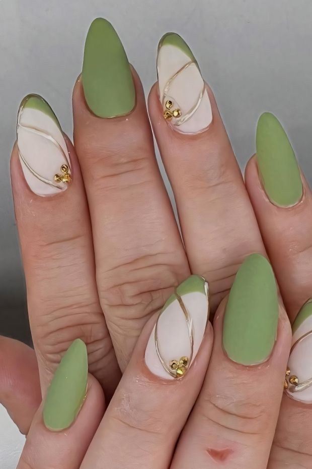Matte green nail designs with gold accents and unique patterns for a stylish look.