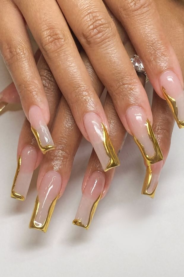 32 Creative Acrylic Nail Ideas You’ll Want to Try This Season 26 Beautiful acrylic nails with nude base and bold gold accents, showcasing a modern and trendy nail art design.