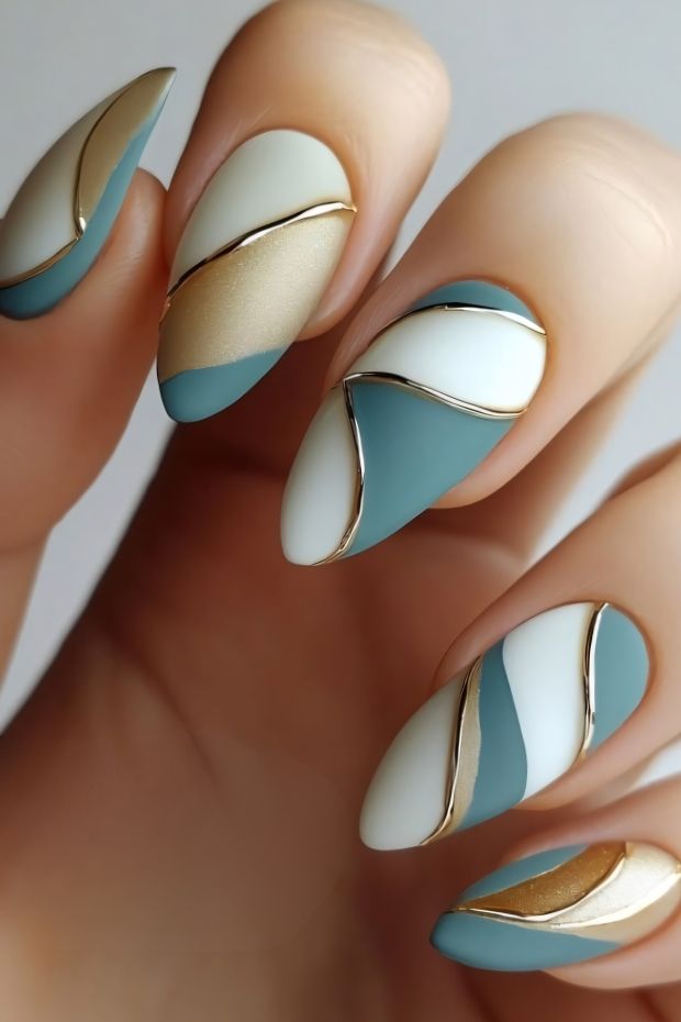 32 Creative Acrylic Nail Ideas You’ll Want to Try This Season 22 Stylish acrylic nails featuring teal, white, and gold designs with unique patterns and accent lines for a modern twist.