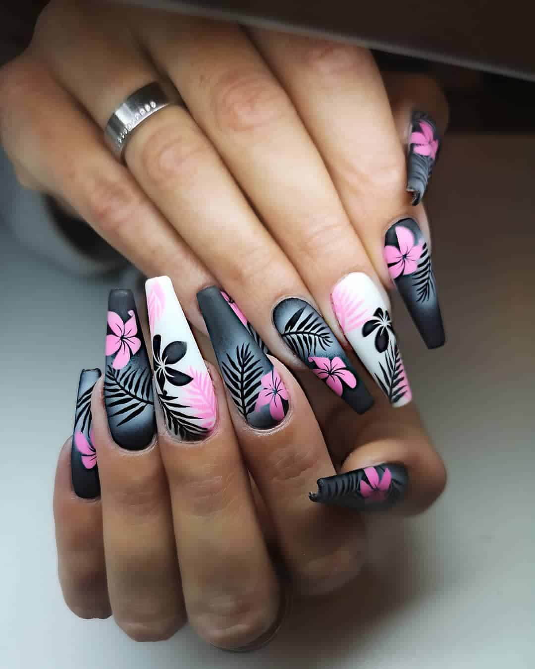 Coffin nails are a great trend in the nail art world and this post highlights 21 different coffin designs that you should try right now! This post features lots of different shapes and sizes, and will provide you with inspiration for your next manicure. #coffinnails #coffinnailart #coffinnaildesigns #coffinacrylicnails