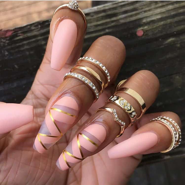 Coffin nails are a great trend in the nail art world and this post highlights 21 different coffin designs that you should try right now! This post features lots of different shapes and sizes, and will provide you with inspiration for your next manicure. #coffinnails #coffinnailart #coffinnaildesigns #coffinacrylicnails